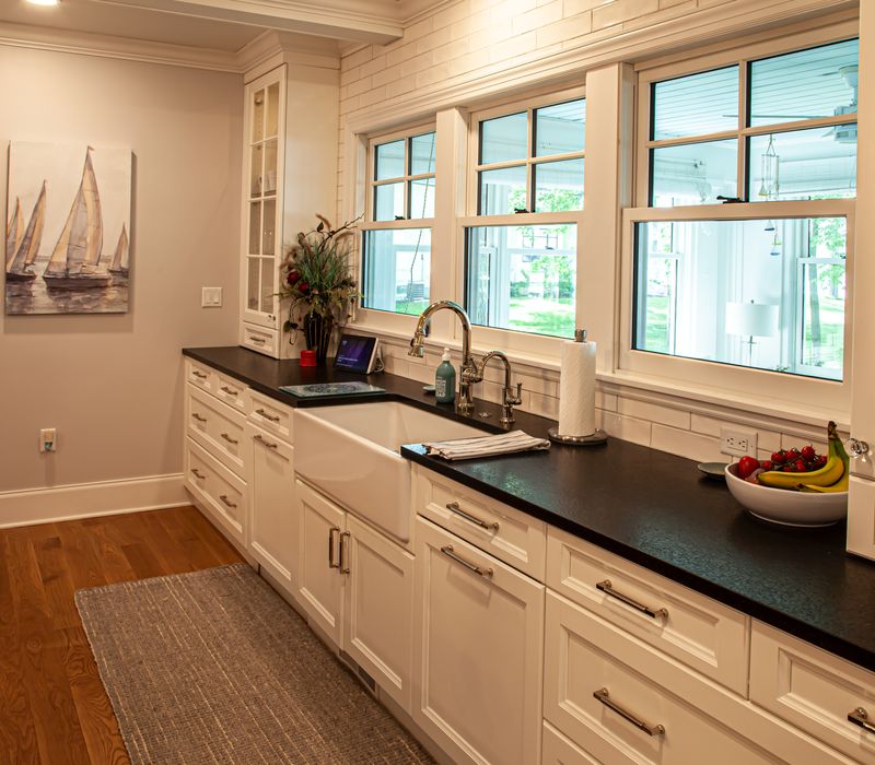 Subway tiles, white cabinetry, and coffered and beadboard ceilings add a sophisticated touch to this comfortable classic home. 