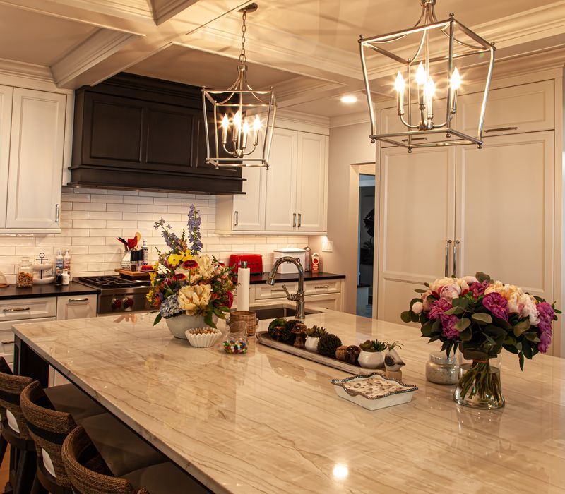 Subway tiles, white cabinetry, and coffered and beadboard ceilings add a sophisticated touch to this comfortable classic home. 