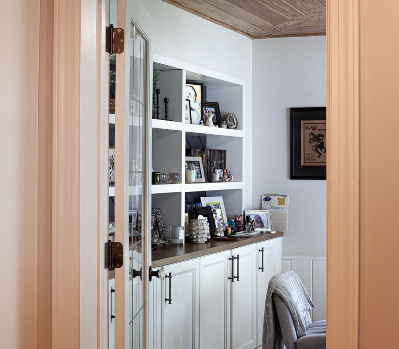 Subway tiles, white cabinetry, and coffered and beadboard ceilings add a sophisticated touch to this comfortable classic home. 