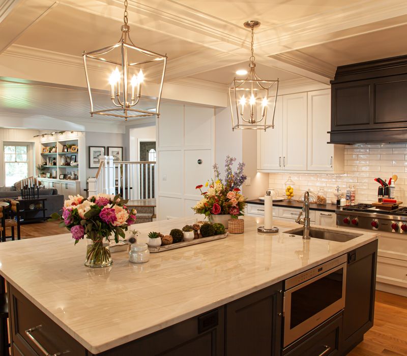 Subway tiles, white cabinetry, and coffered and beadboard ceilings add a sophisticated touch to this comfortable classic home. 