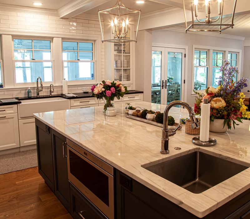 Subway tiles, white cabinetry, and coffered and beadboard ceilings add a sophisticated touch to this comfortable classic home. 