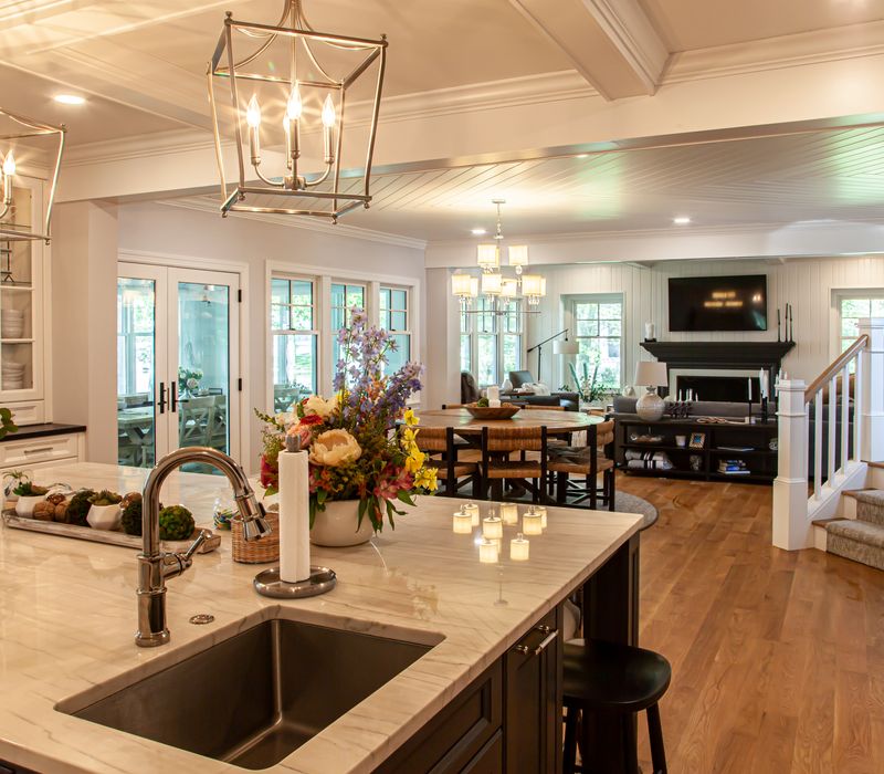 Subway tiles, white cabinetry, and coffered and beadboard ceilings add a sophisticated touch to this comfortable classic home. 