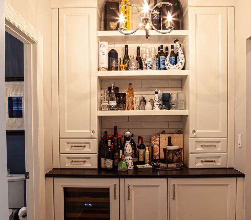 Subway tiles, white cabinetry, and coffered and beadboard ceilings add a sophisticated touch to this comfortable classic home. 