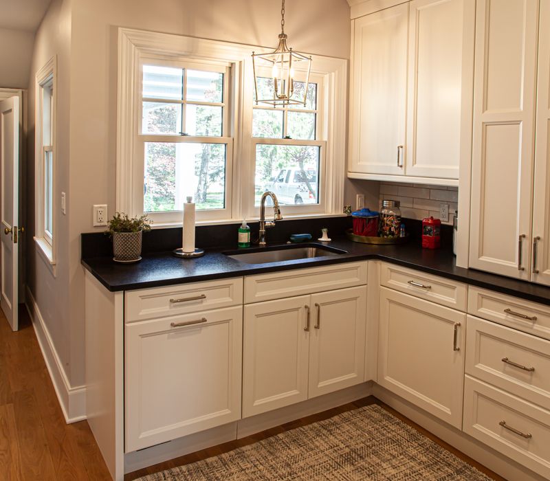 Subway tiles, white cabinetry, and coffered and beadboard ceilings add a sophisticated touch to this comfortable classic home. 