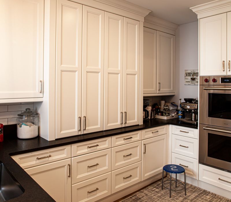 Subway tiles, white cabinetry, and coffered and beadboard ceilings add a sophisticated touch to this comfortable classic home. 