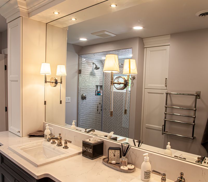 Subway tiles, white cabinetry, and coffered and beadboard ceilings add a sophisticated touch to this comfortable classic home. 