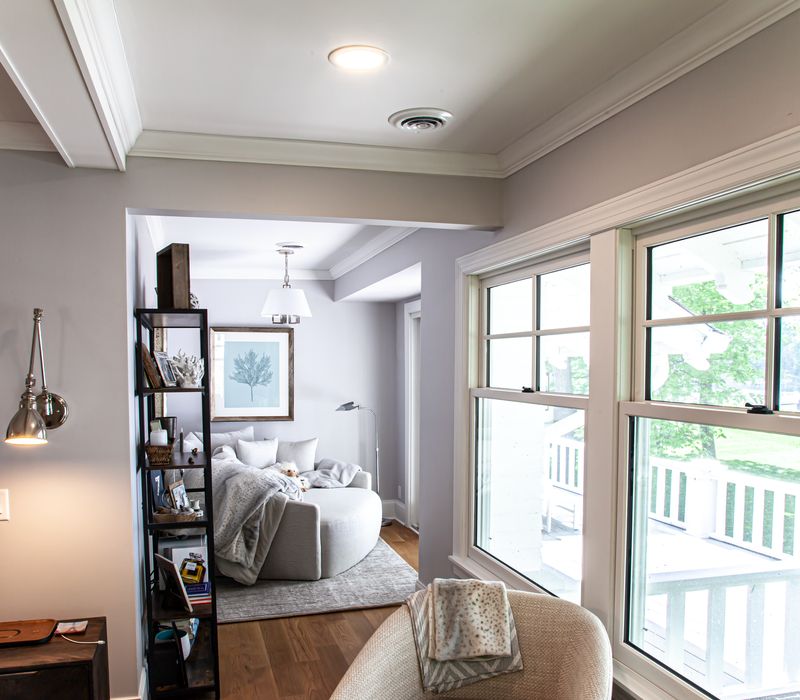 Subway tiles, white cabinetry, and coffered and beadboard ceilings add a sophisticated touch to this comfortable classic home. 