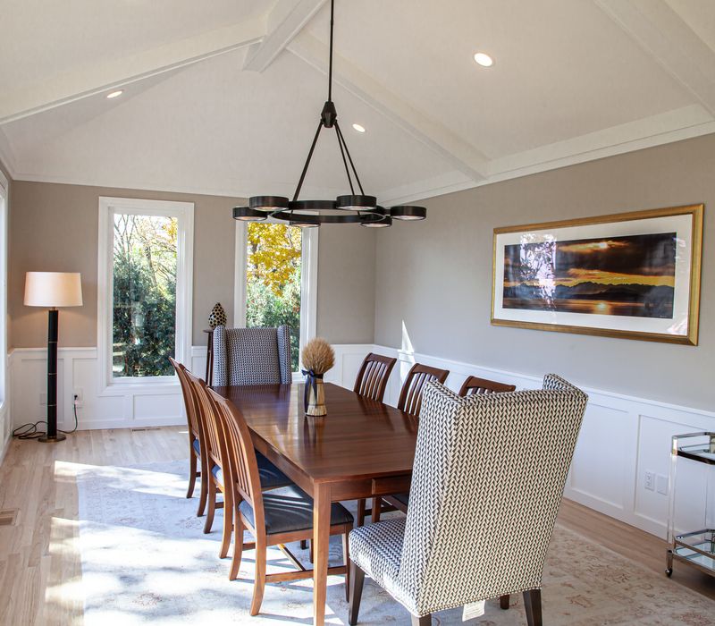 This lakeside brick home has vaulted and coffered ceilings, twin picture windows on either side of a fireplace, hardwood floors, two second-story decks, and a finished basement. 