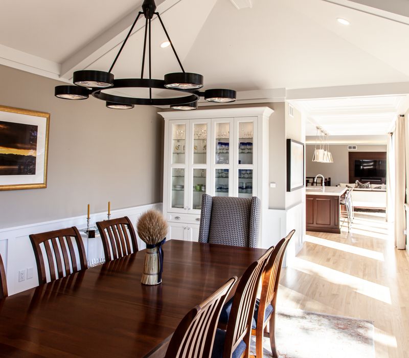 This lakeside brick home has vaulted and coffered ceilings, twin picture windows on either side of a fireplace, hardwood floors, two second-story decks, and a finished basement. 