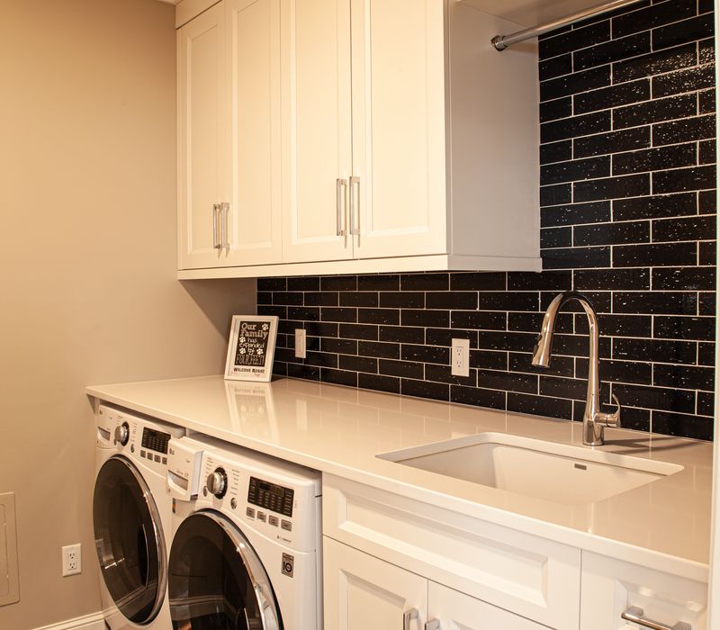 This lakeside brick home has vaulted and coffered ceilings, twin picture windows on either side of a fireplace, hardwood floors, two second-story decks, and a finished basement. 