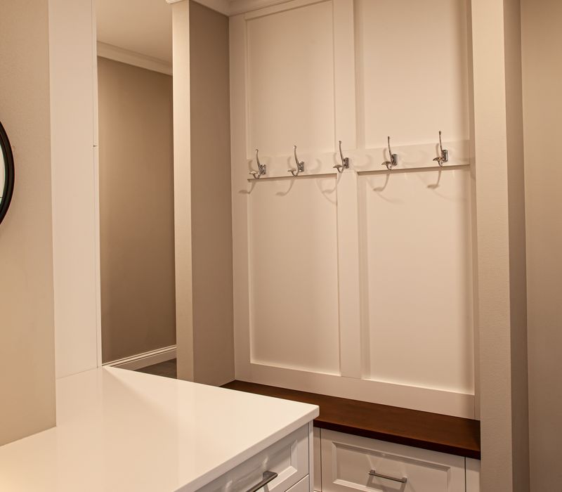 This lakeside brick home has vaulted and coffered ceilings, twin picture windows on either side of a fireplace, hardwood floors, two second-story decks, and a finished basement. 