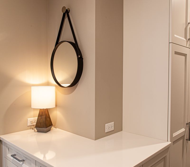 This lakeside brick home has vaulted and coffered ceilings, twin picture windows on either side of a fireplace, hardwood floors, two second-story decks, and a finished basement. 