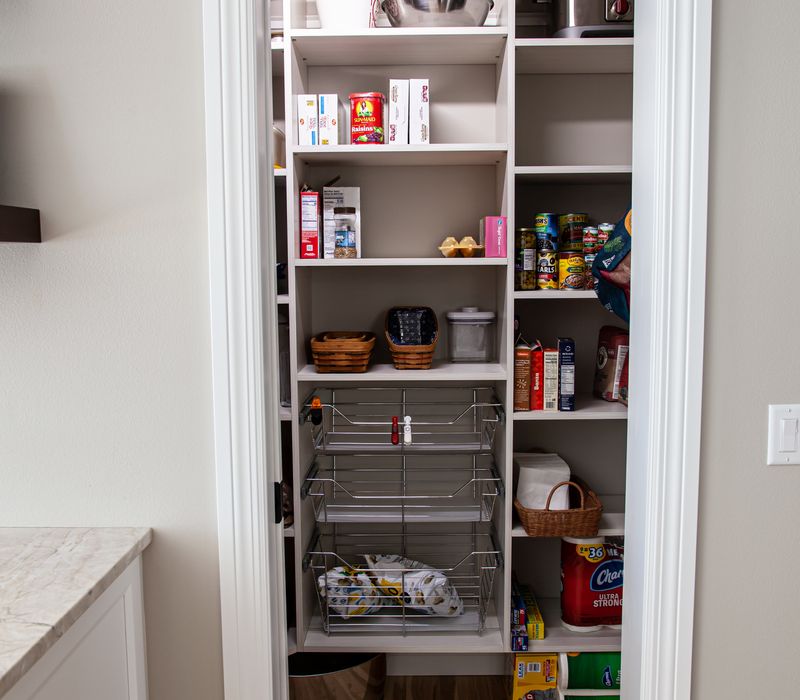 This lakeside brick home has vaulted and coffered ceilings, twin picture windows on either side of a fireplace, hardwood floors, two second-story decks, and a finished basement. 