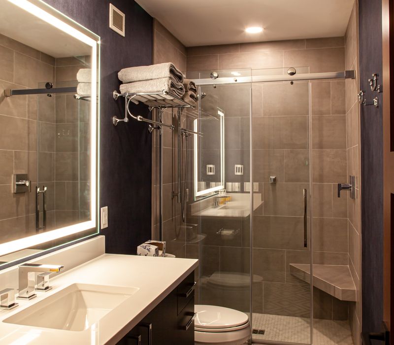 This lakeside brick home has vaulted and coffered ceilings, twin picture windows on either side of a fireplace, hardwood floors, two second-story decks, and a finished basement. 