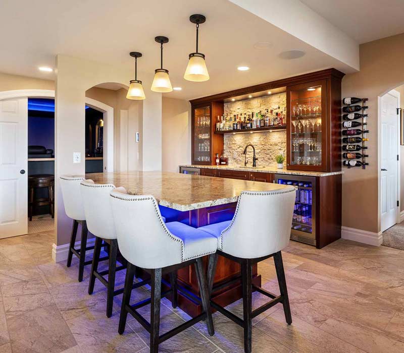 We transformed this basement into a luxurious retreat complete with a theater room, family room, bar, and game room. The remodel employs a traditional style and elevates everyday living.