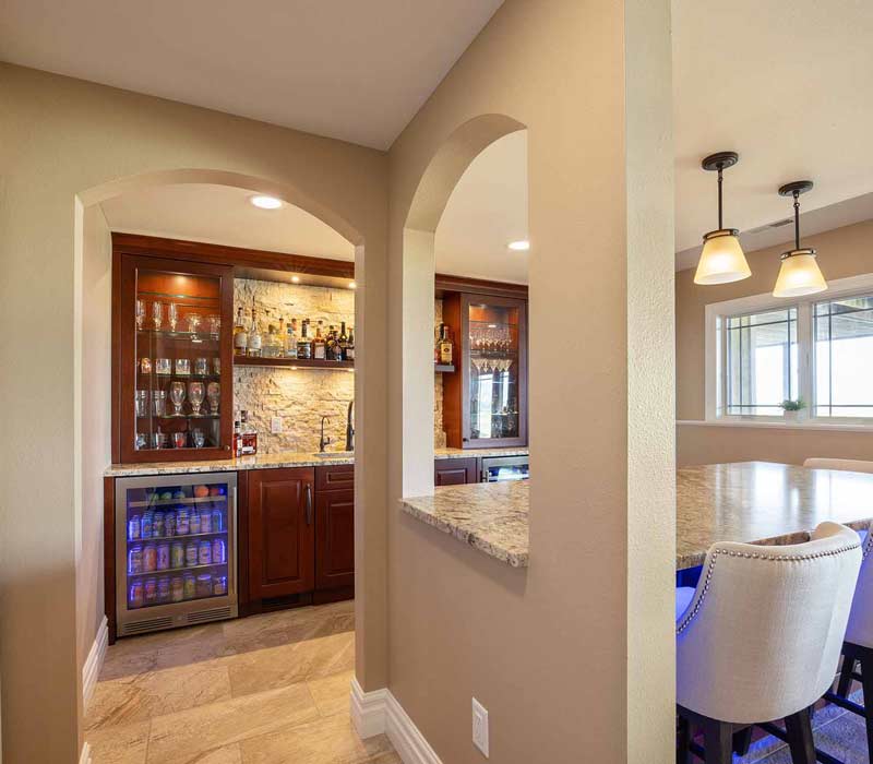 We transformed this basement into a luxurious retreat complete with a theater room, family room, bar, and game room. The remodel employs a traditional style and elevates everyday living.