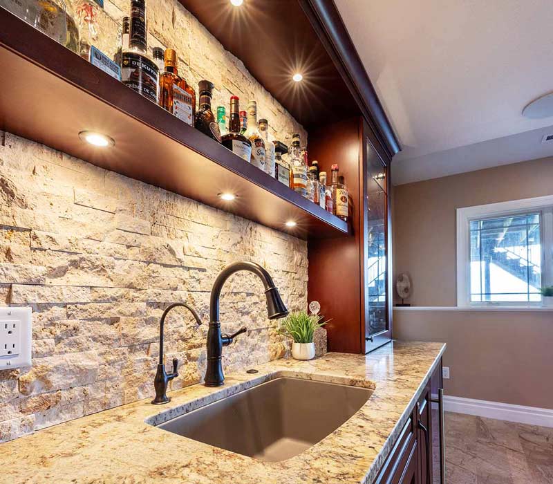 We transformed this basement into a luxurious retreat complete with a theater room, family room, bar, and game room. The remodel employs a traditional style and elevates everyday living.