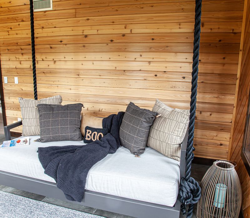 This house includes a brushed steel range hood, a live edge countertop, stone-seeded glass pendant lamps, skylights, and a barn door pantry. 