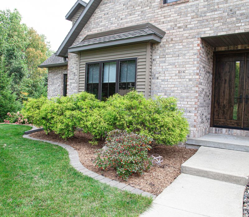 This house includes a brushed steel range hood, a live edge countertop, stone-seeded glass pendant lamps, skylights, and a barn door pantry. 
