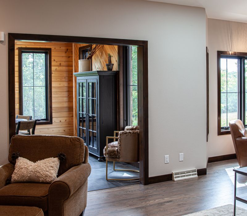 This house includes a brushed steel range hood, a live edge countertop, stone-seeded glass pendant lamps, skylights, and a barn door pantry. 