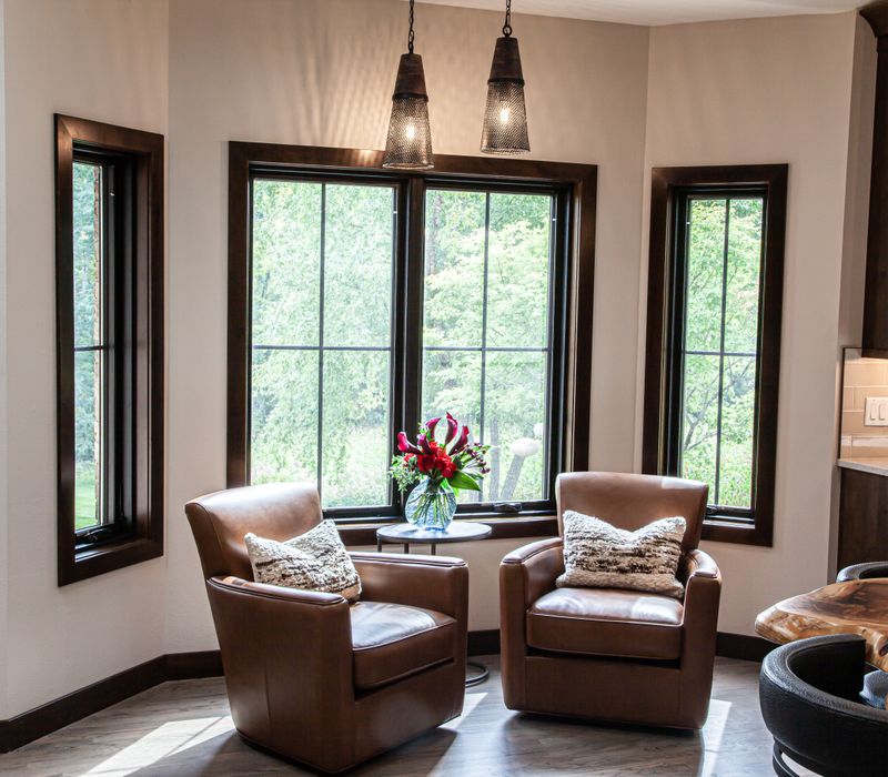 This house includes a brushed steel range hood, a live edge countertop, stone-seeded glass pendant lamps, skylights, and a barn door pantry. 