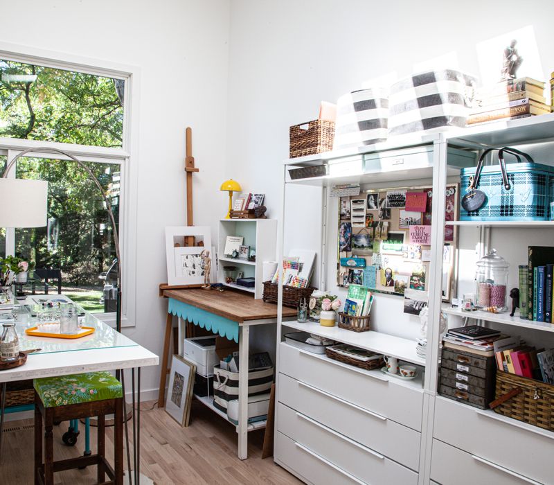 This remodeled split-level home features retro touches in an open contemporary space, and includes a craft room, central brick fireplace, exposed wood ceiling beams, and an open riser staircase. 