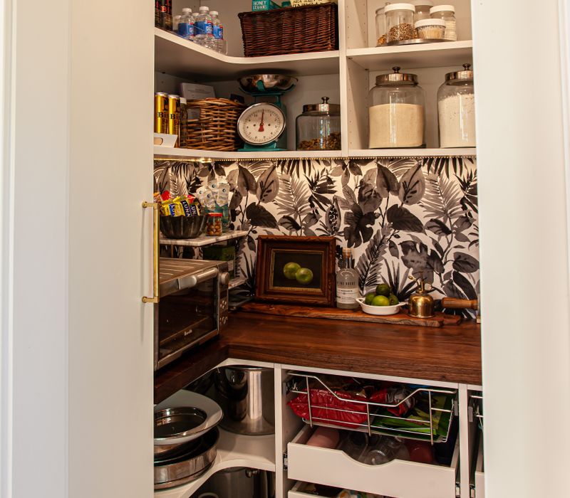 This remodeled split-level home features retro touches in an open contemporary space, and includes a craft room, central brick fireplace, exposed wood ceiling beams, and an open riser staircase. 