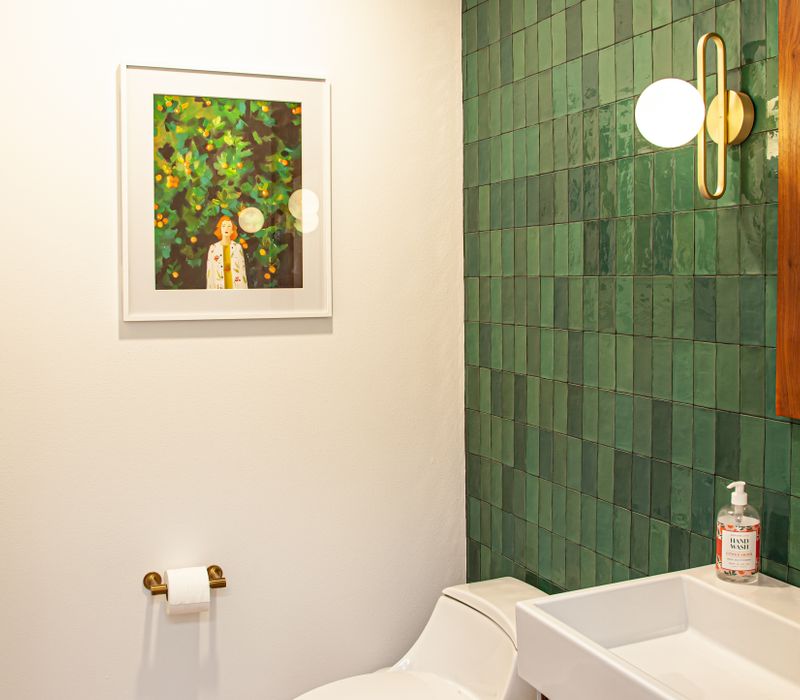 This remodeled split-level home features retro touches in an open contemporary space, and includes a craft room, central brick fireplace, exposed wood ceiling beams, and an open riser staircase. 