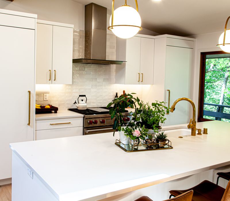 This remodeled split-level home features retro touches in an open contemporary space, and includes a craft room, central brick fireplace, exposed wood ceiling beams, and an open riser staircase. 