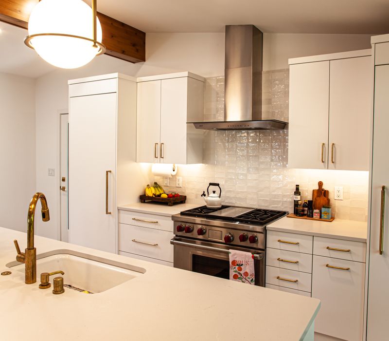 This remodeled split-level home features retro touches in an open contemporary space, and includes a craft room, central brick fireplace, exposed wood ceiling beams, and an open riser staircase. 