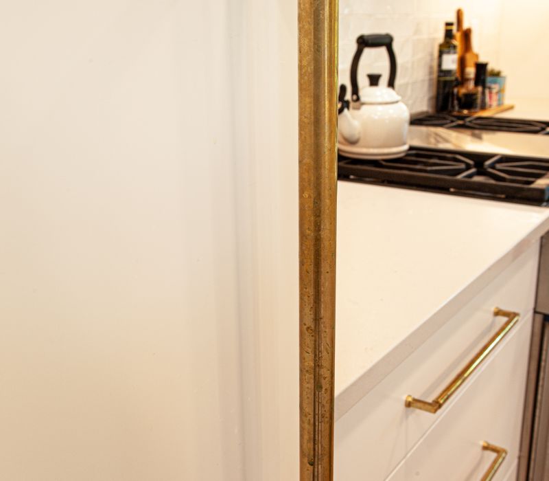 This remodeled split-level home features retro touches in an open contemporary space, and includes a craft room, central brick fireplace, exposed wood ceiling beams, and an open riser staircase. 