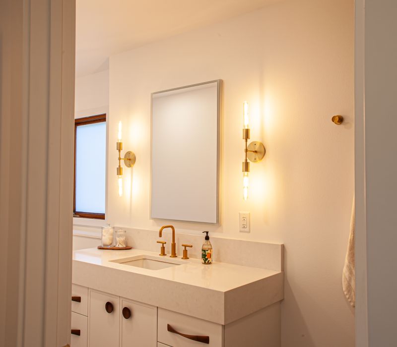 This remodeled split-level home features retro touches in an open contemporary space, and includes a craft room, central brick fireplace, exposed wood ceiling beams, and an open riser staircase. 