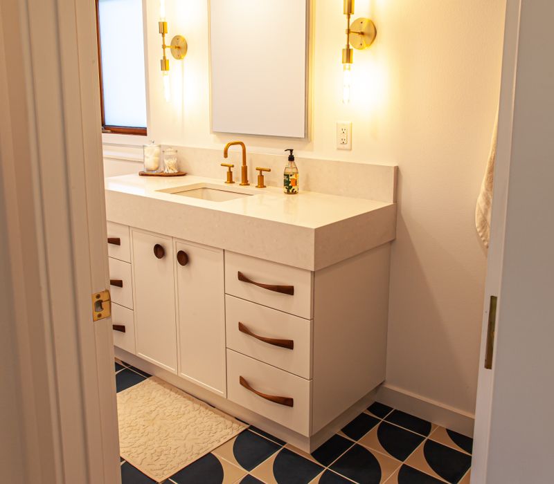 This remodeled split-level home features retro touches in an open contemporary space, and includes a craft room, central brick fireplace, exposed wood ceiling beams, and an open riser staircase. 