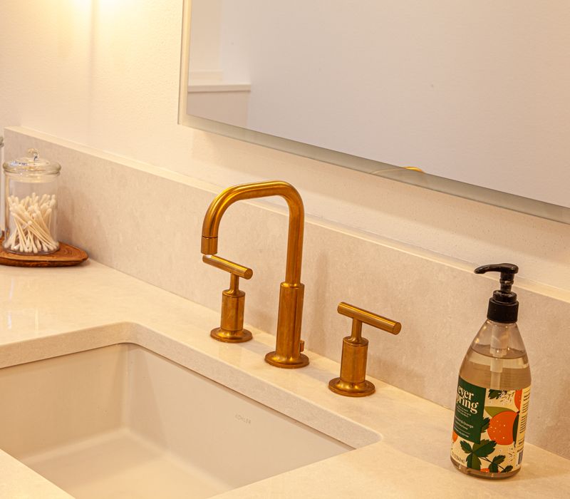 This remodeled split-level home features retro touches in an open contemporary space, and includes a craft room, central brick fireplace, exposed wood ceiling beams, and an open riser staircase. 