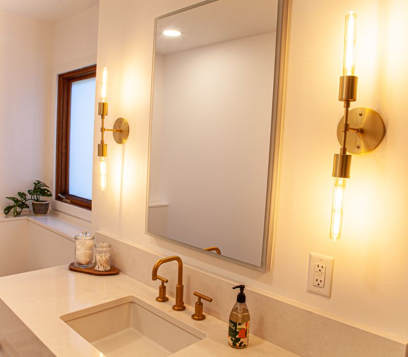 This remodeled split-level home features retro touches in an open contemporary space, and includes a craft room, central brick fireplace, exposed wood ceiling beams, and an open riser staircase. 