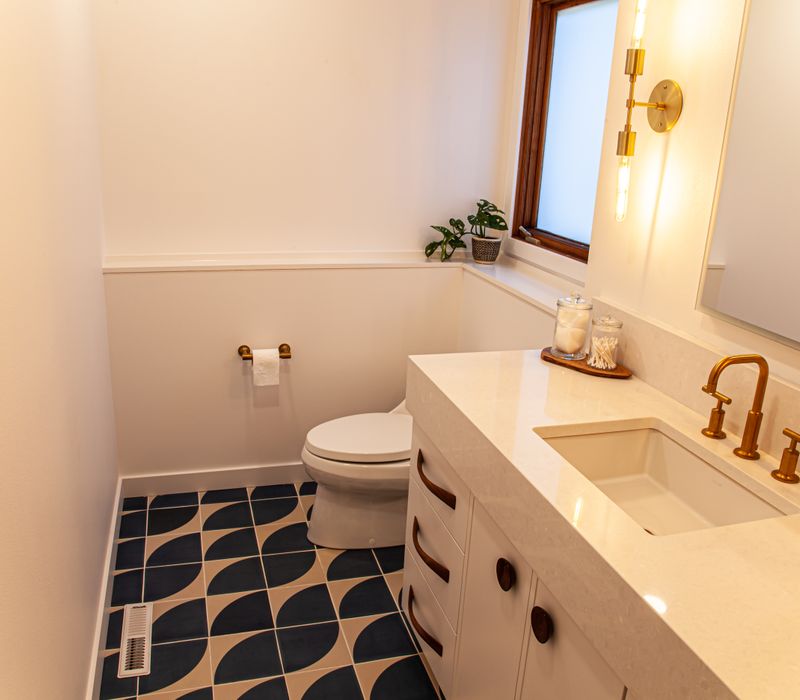 This remodeled split-level home features retro touches in an open contemporary space, and includes a craft room, central brick fireplace, exposed wood ceiling beams, and an open riser staircase. 