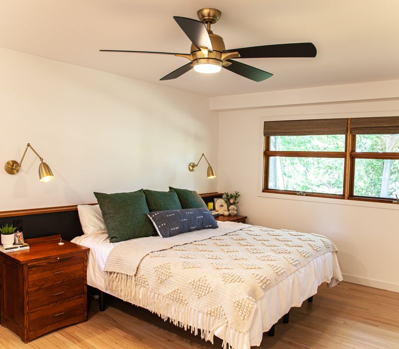 This remodeled split-level home features retro touches in an open contemporary space, and includes a craft room, central brick fireplace, exposed wood ceiling beams, and an open riser staircase. 