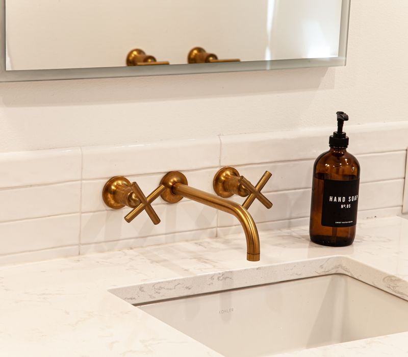 This remodeled split-level home features retro touches in an open contemporary space, and includes a craft room, central brick fireplace, exposed wood ceiling beams, and an open riser staircase. 