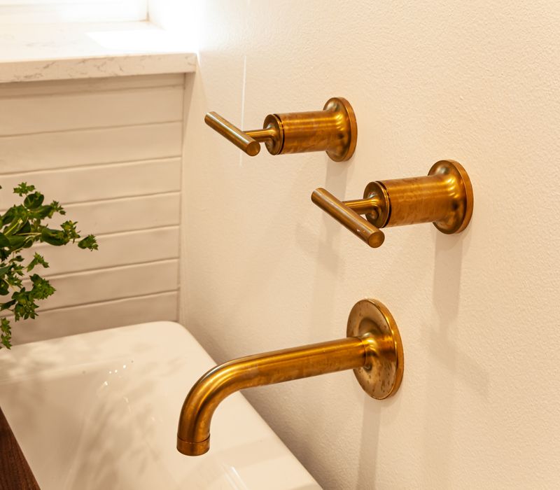 This remodeled split-level home features retro touches in an open contemporary space, and includes a craft room, central brick fireplace, exposed wood ceiling beams, and an open riser staircase. 