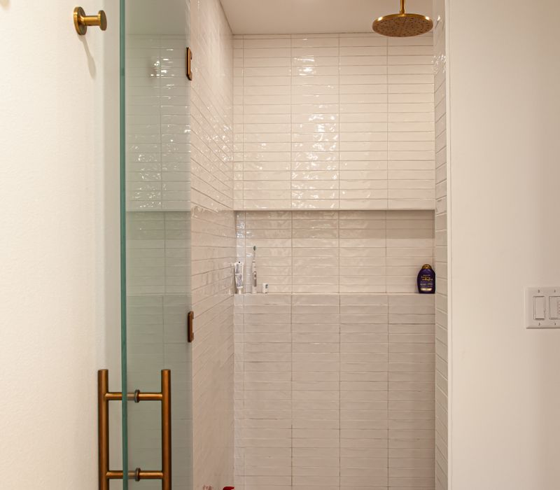 This remodeled split-level home features retro touches in an open contemporary space, and includes a craft room, central brick fireplace, exposed wood ceiling beams, and an open riser staircase. 