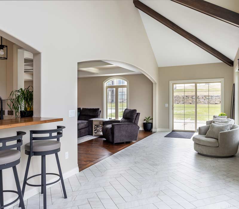 With a refined transitional style and a palette of timeless neutrals, this home addition harmonizes perfectly with the house’s original character. The project added a flex space, new family room, children's nook, and luxe laundry room.