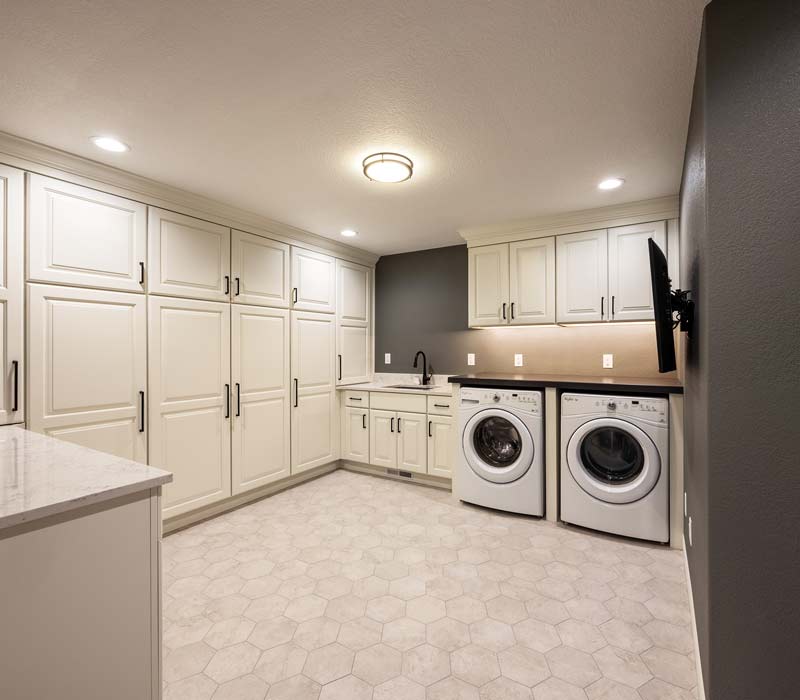 With a refined transitional style and a palette of timeless neutrals, this home addition harmonizes perfectly with the house’s original character. The project added a flex space, new family room, children's nook, and luxe laundry room.