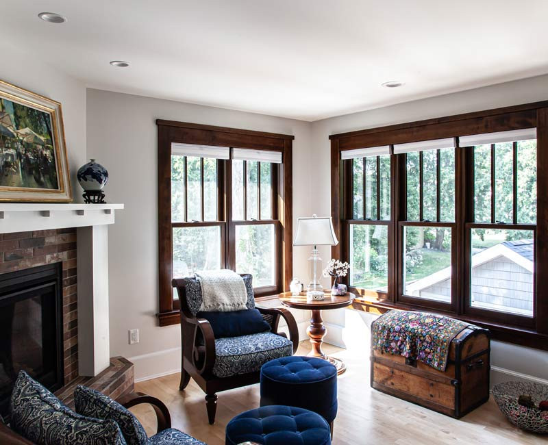 Dark woodwork, patterned terra cotta tile floors, and exposed brick interior walls define the kitchen and addition of this Craftsman home.