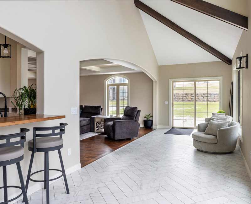 With a refined transitional style and a palette of timeless neutrals, this home addition harmonizes perfectly with the house’s original character. The project added a flex space, new family room, children's nook, and luxe laundry room.
